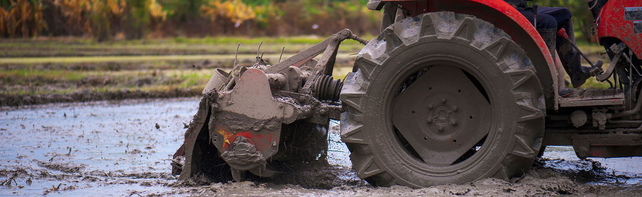a close-up of a tractor in the mud